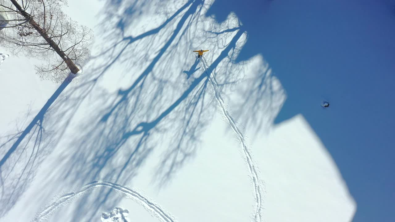 鸟瞰图的一个人有乐趣在深雪画人物的脚视频下载