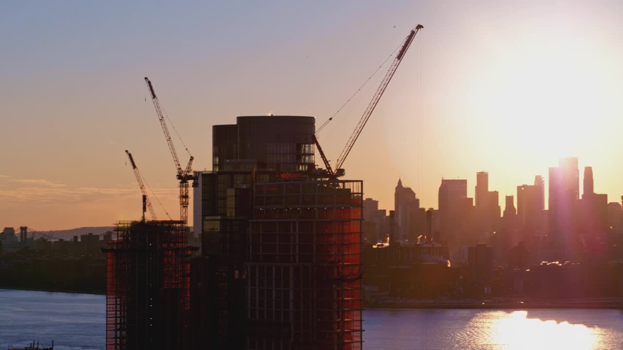 布鲁克林滨水区新建住宅楼，日落时分，可以看到曼哈顿下城的天际线和自由塔的美景。航拍视频与平移摄像机运动。视频素材