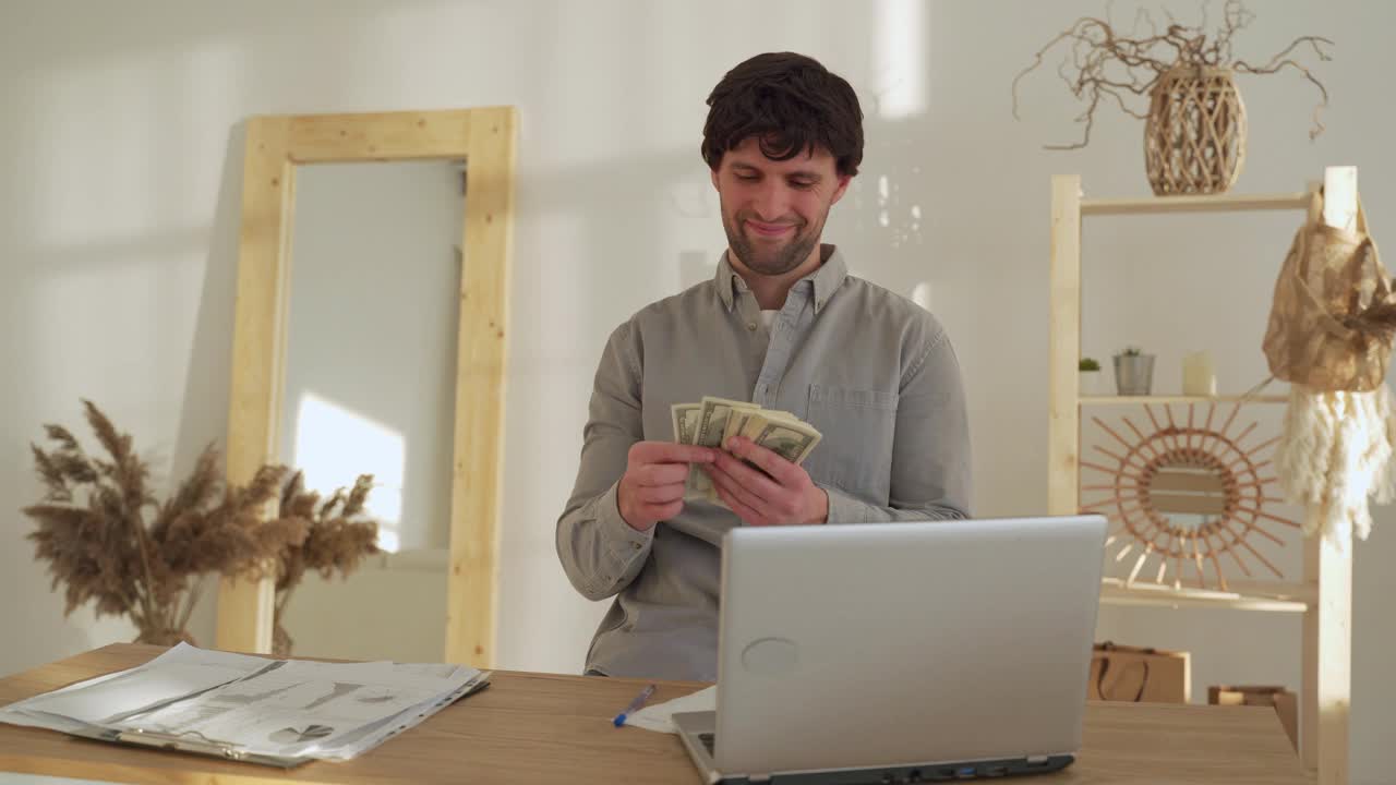 微笑的商人坐在办公室数钱。成功的商人挣钱视频素材