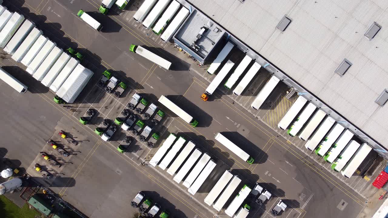 配货仓库鸟瞰图，装卸区设有货车。锁住。视频下载