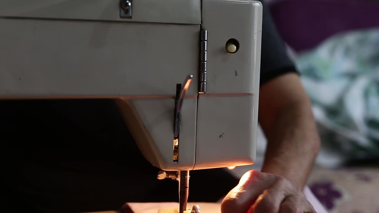 在缝纫机上在被套上缝纽扣的妇女视频素材