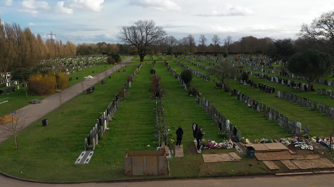 英国伦敦的一个公墓里，一个家庭在一个坟墓上参观视频下载