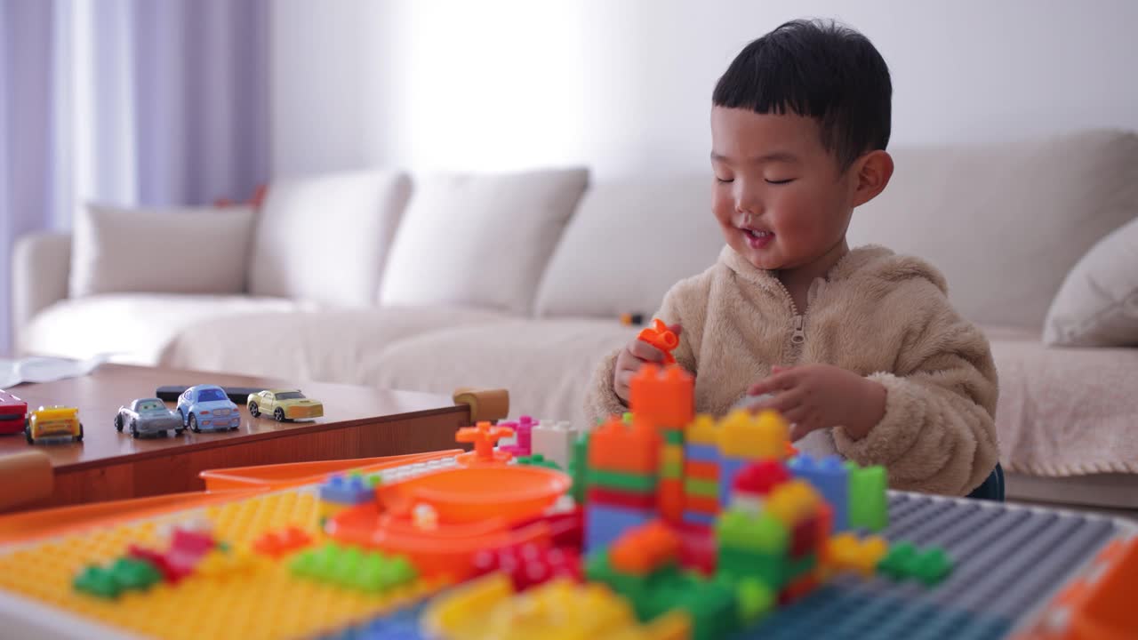 蹒跚学步的小男孩在家里玩积木视频素材