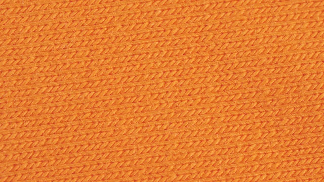 纺织品背景-橙色棉弹性(起泡器，莱卡)弹性织物视频下载