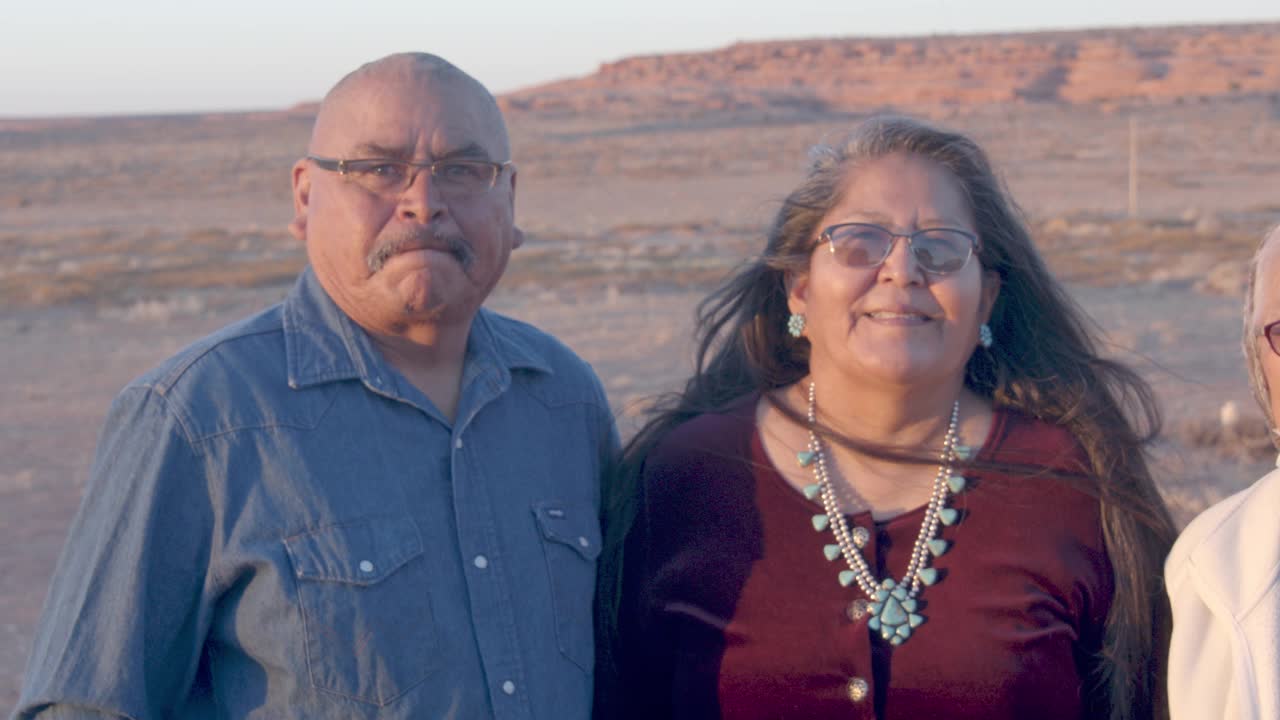 在犹他州纪念碑谷，一个泄气的美国土著家庭的肖像，祖母戴着防护口罩在他们家附近视频素材