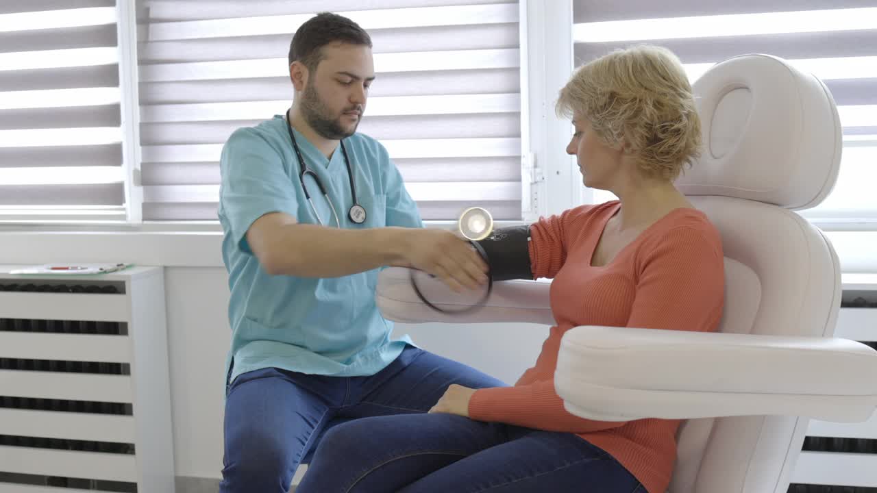 医生测量女病人的血压和听心率视频素材