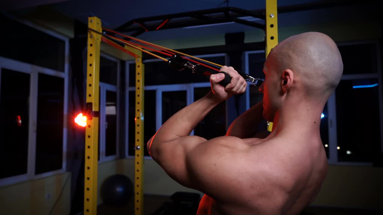 肌肉强壮，出汗的男子二头肌和胸部训练与阻力带视频下载