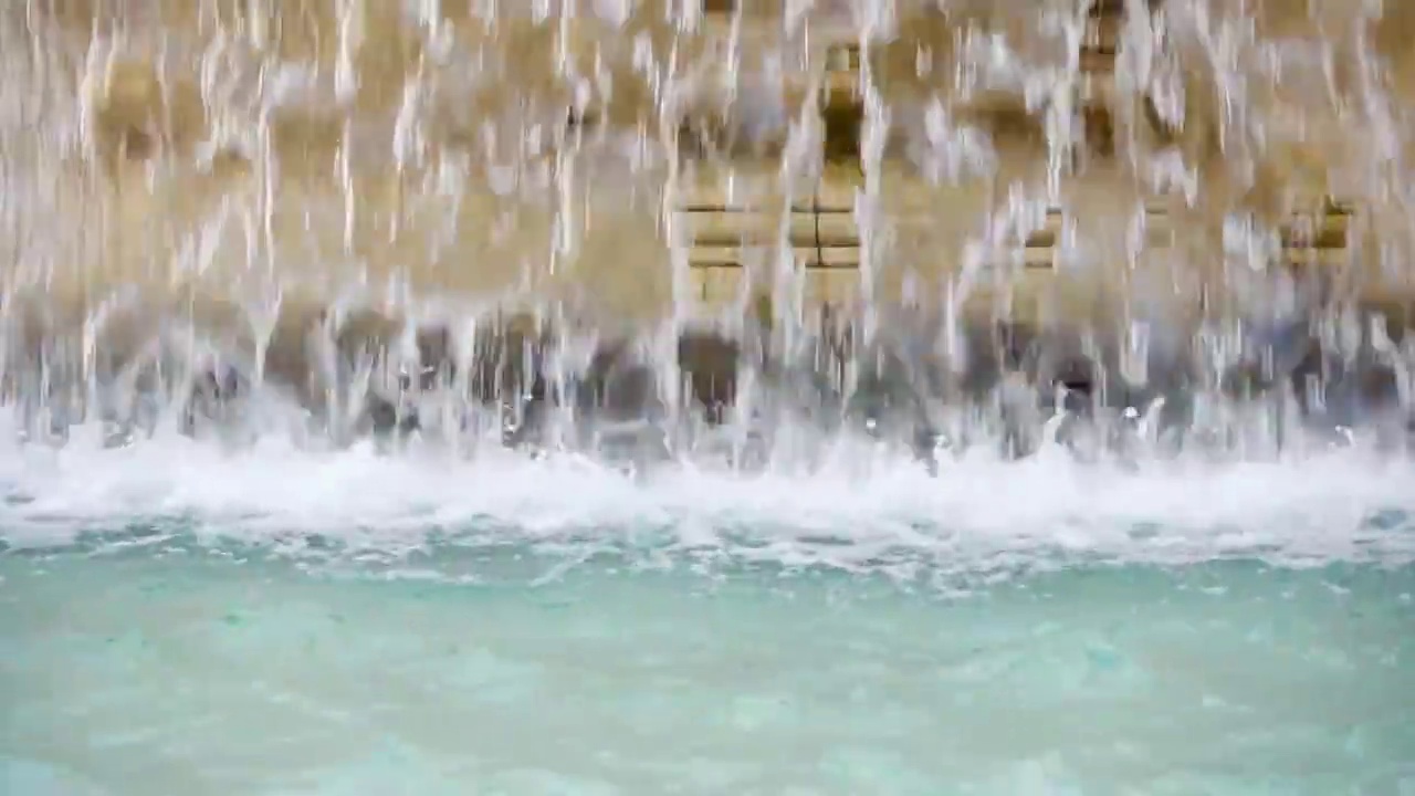 老黄大理石喷泉水幕的特写。透明的水流。夏天阳光灿烂的日子视频素材