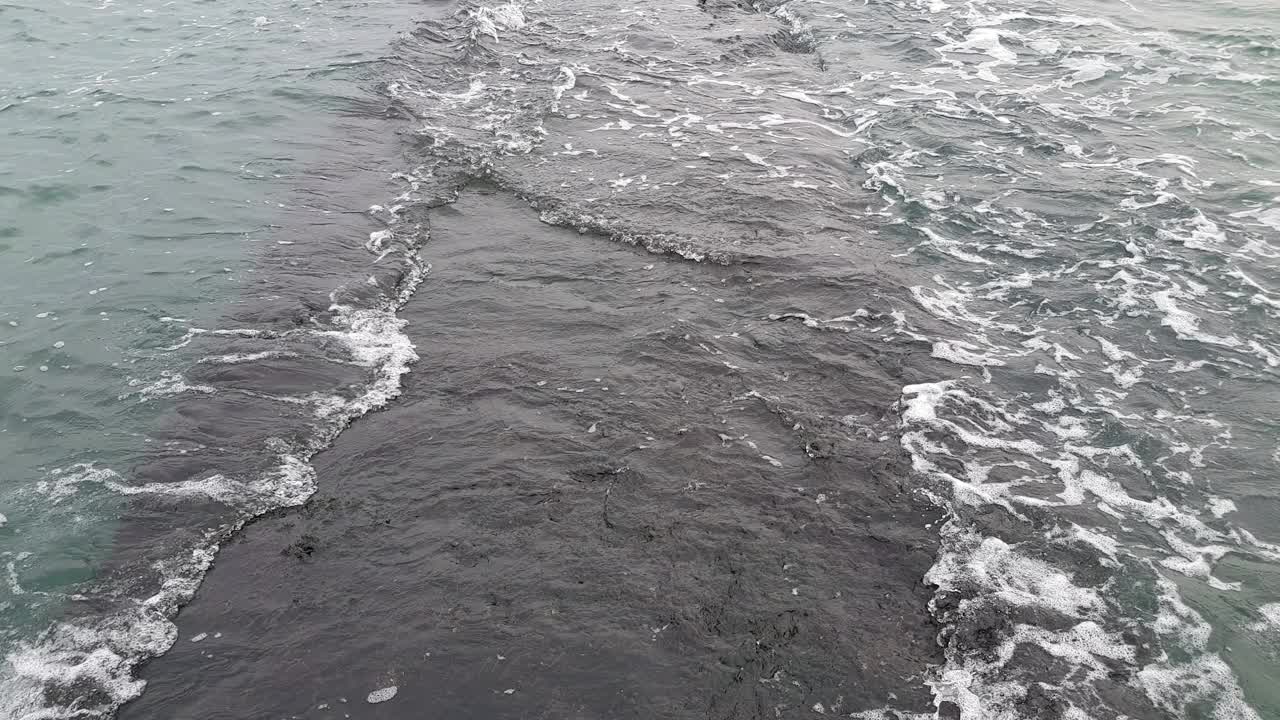 波浪在上面翻滚的石头码头。多云的天气，波涛汹涌的大海。视频下载