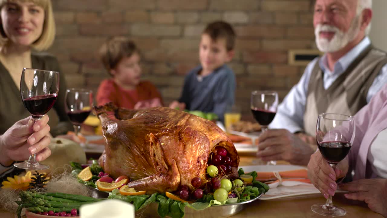 多代同堂的一家人在感恩节餐桌前举杯祝酒视频下载