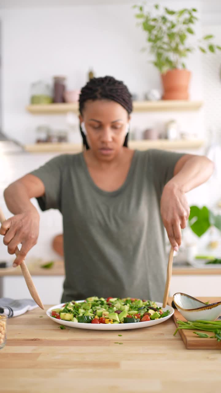 一个女人在厨房里拌蔬菜沙拉视频下载