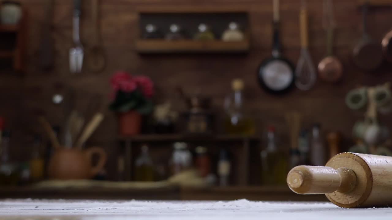 乡村的厨房里，乡村酸面包圆面包落在桌子上的慢镜头视频素材