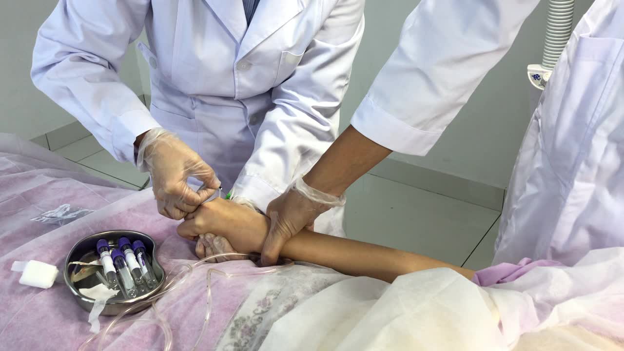 亚洲华人女护士在诊所准备从女性华人病人的手上抽血视频下载