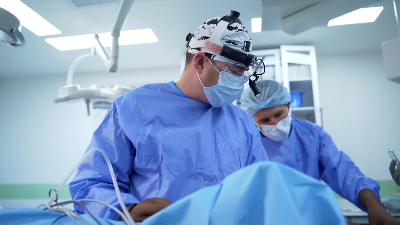 多元化的专业外科医生团队。一组外科医生正在进行精细的手术视频下载