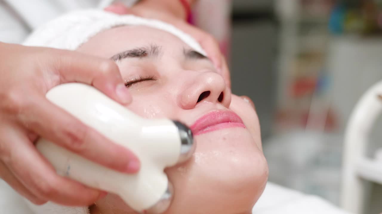 年轻女子得到护理离子治疗面部皮肤视频素材