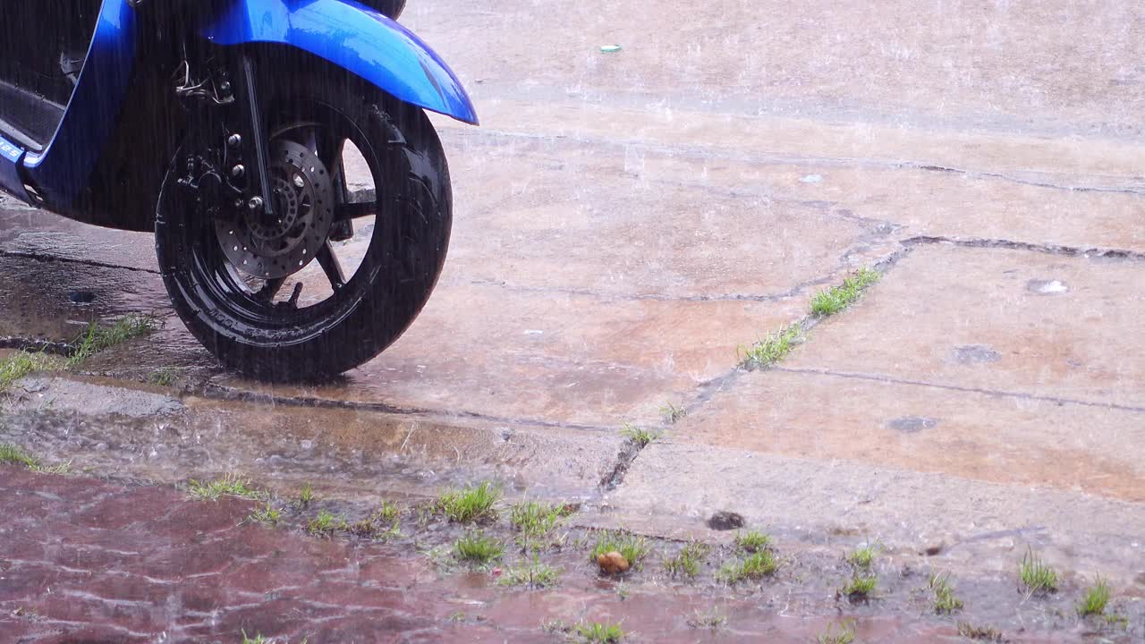 大雨顺着排水沟流下去，摩托车留在村里视频素材