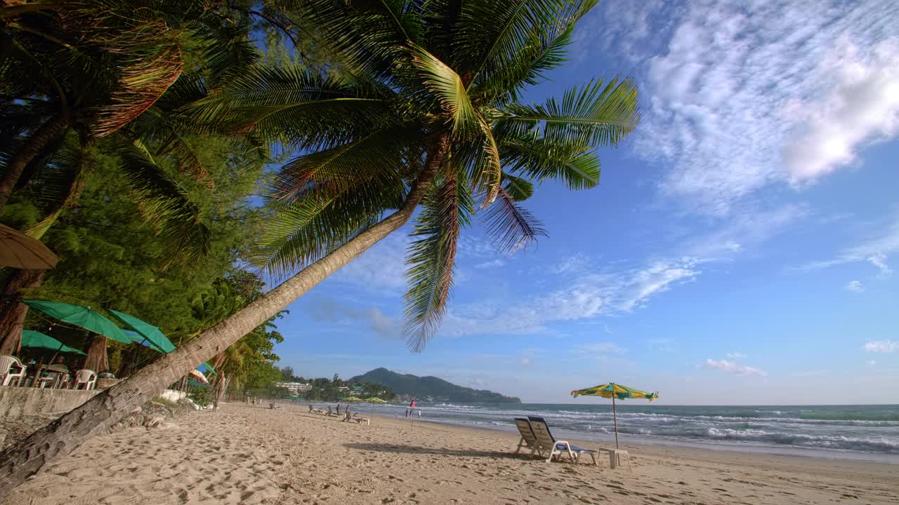 4K假期暑假概念。海滩上的椰子树。椰子树上美丽的热带海岸风景普吉岛泰国著名的旅游胜地安达曼海自由海滩视频素材