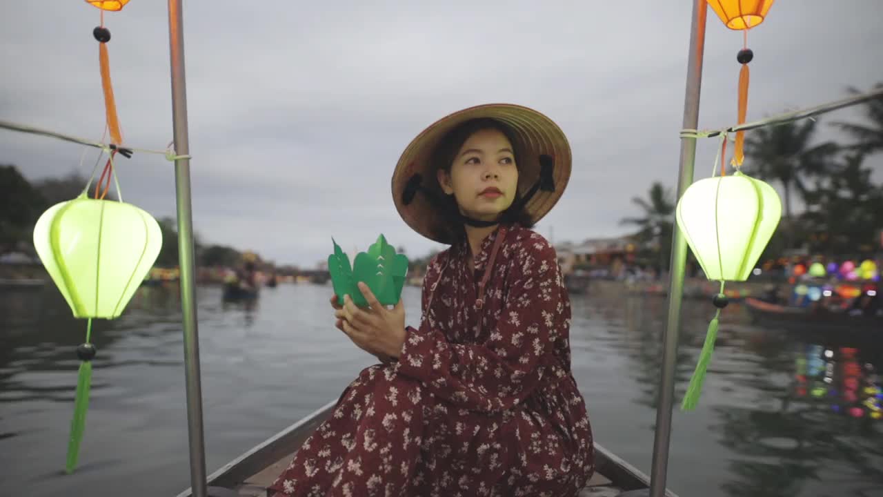 会安元宵节，船上的年轻女子戴着越南传统的帽子视频下载