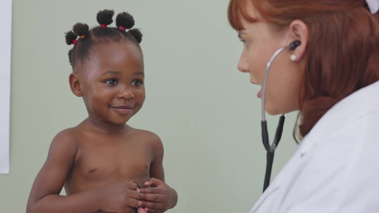 一个医生用听诊器给一个可爱的小女孩做检查的4k视频视频素材