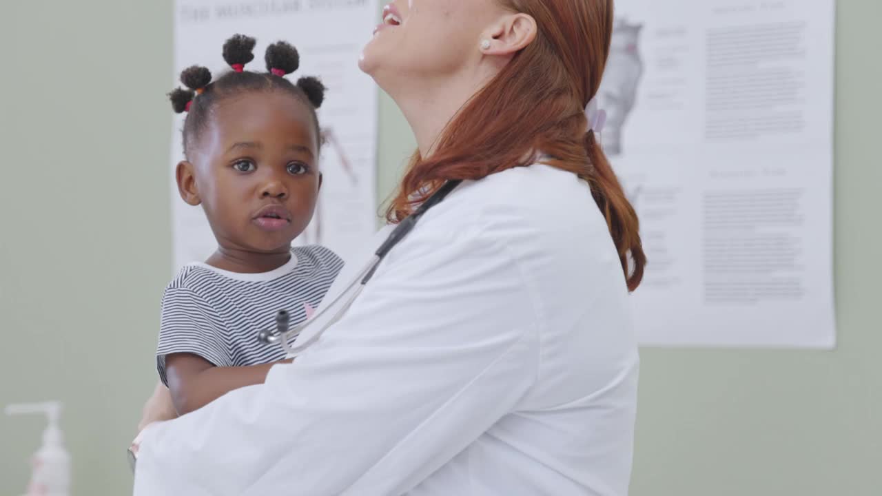 一段4k视频记录了一名女医生在会诊期间与一名小女孩嬉戏视频素材