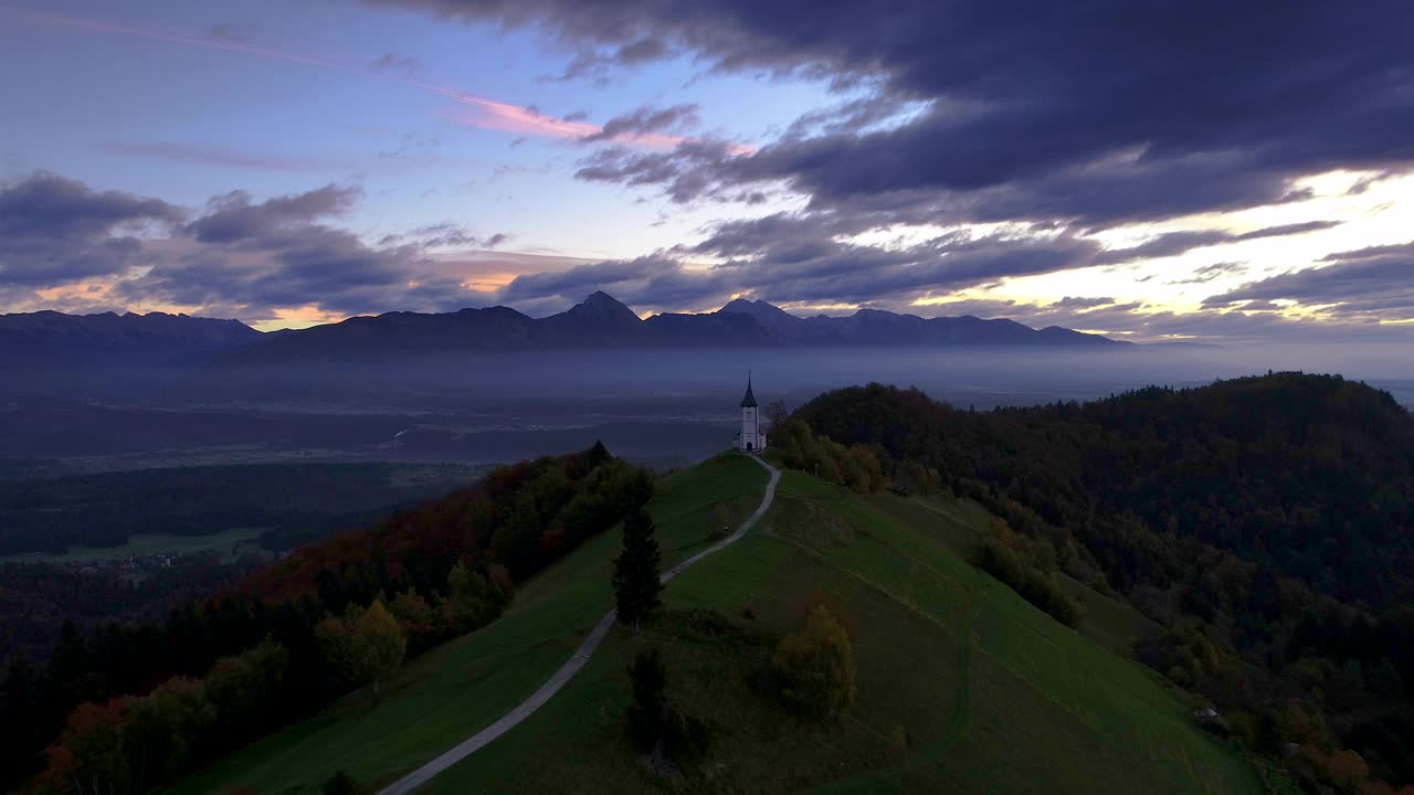 鸟瞰斯洛文尼亚萨瓦山谷上方的山丘和圣托马斯教堂的山景视频素材