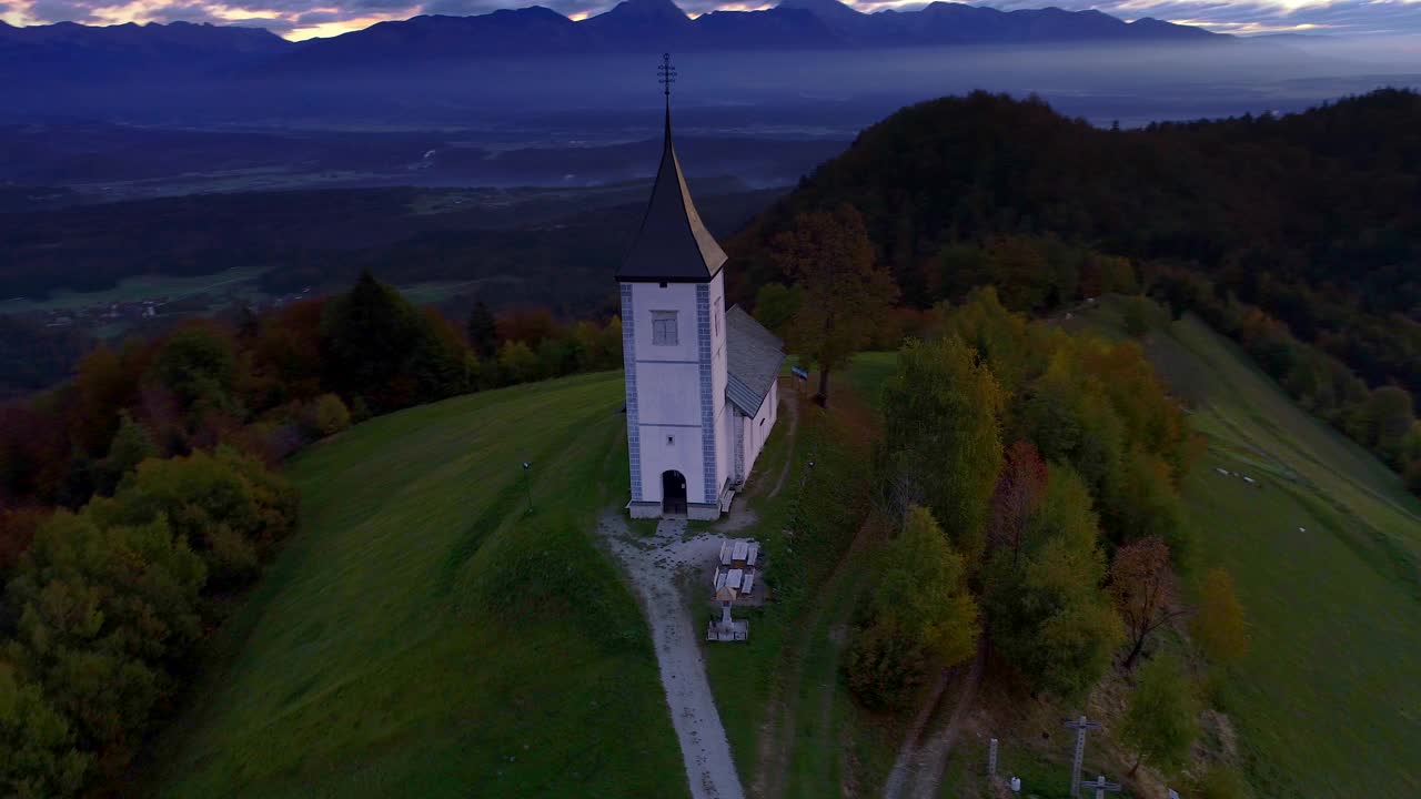 鸟瞰斯洛文尼亚萨瓦山谷上方的山丘和圣托马斯教堂的山景视频素材