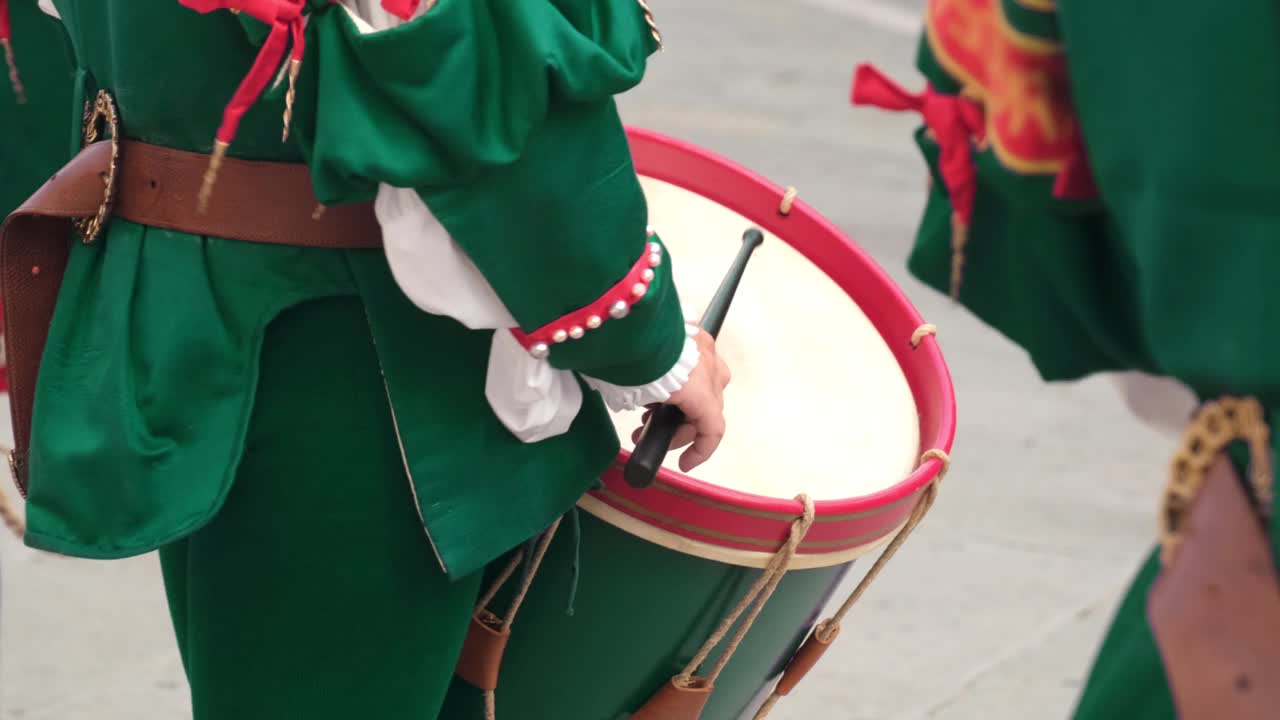 身穿传统服装的鼓手在街头庆祝活动中打鼓视频下载