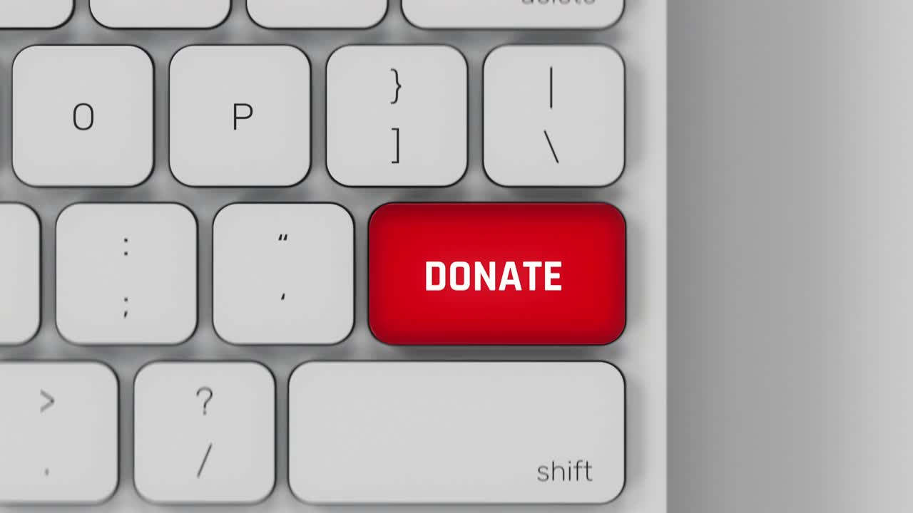 捐赠白色电脑键盘上的红色脉冲按键，慈善基金会视频素材