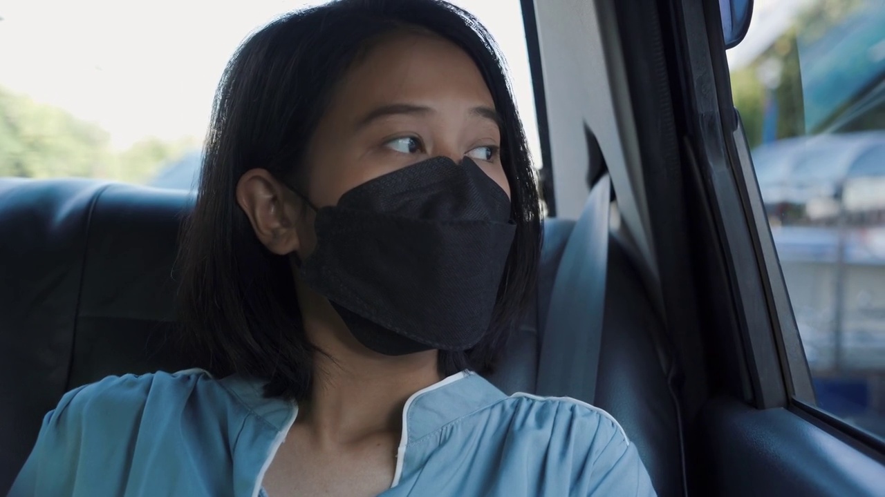 亚洲妇女在车里戴口罩视频素材