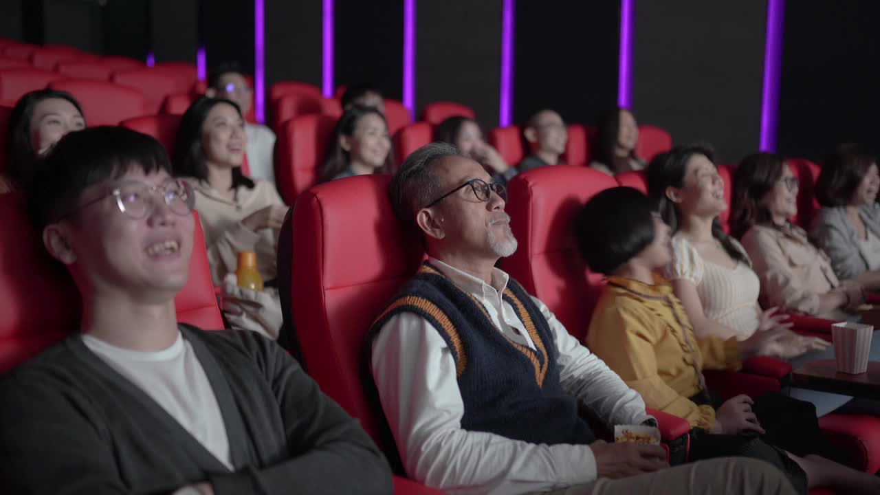 亚洲华人老人和孙女在电影院看电影睡着了视频素材