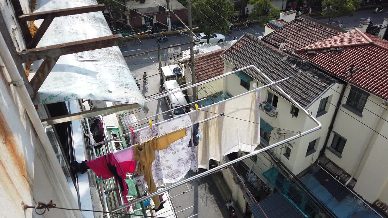 中国上海，中国妇女把洗好的衣服挂在窗户上晾干视频下载