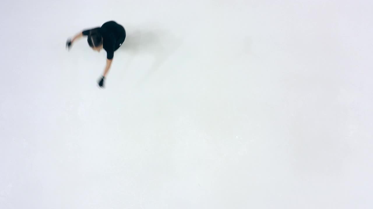 一个小女孩正在做旋转滑冰在一个俯视图视频素材