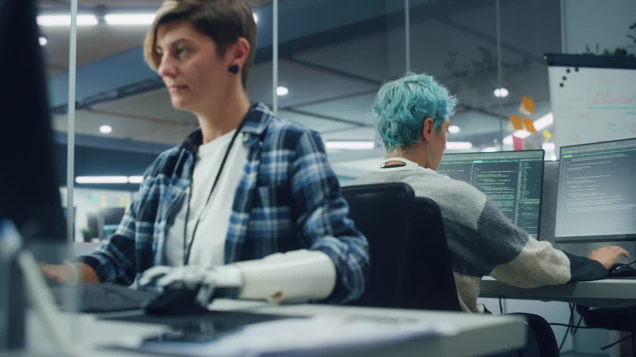 多元身体积极办公室:积极的残疾妇女肖像使用假肢在电脑上工作。勇敢的专业人士与未来的思想控制肌电仿生手视频下载