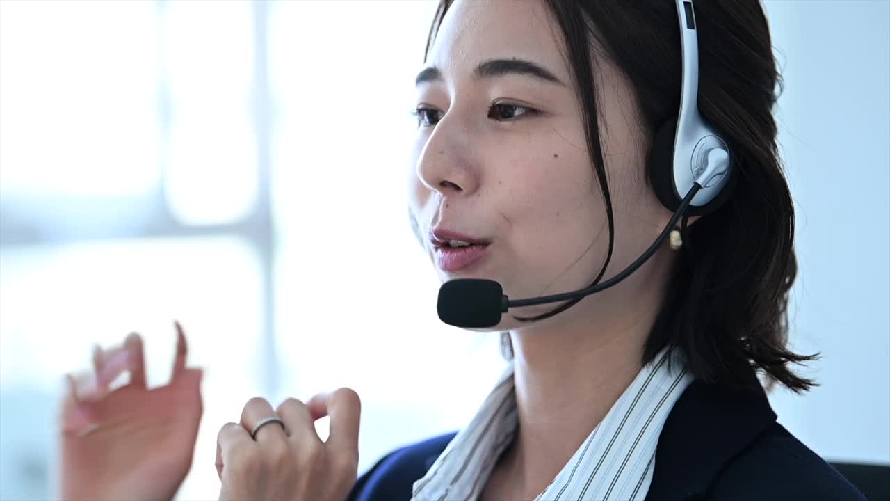 亚洲年轻女性呼叫中心员工在办公室提供专业的客户服务。视频下载