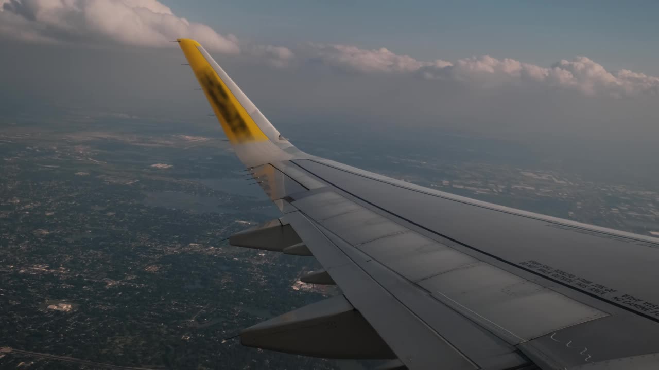 在云层上飞行的飞机的机翼。从飞机的窗户看。广角镜头视频素材