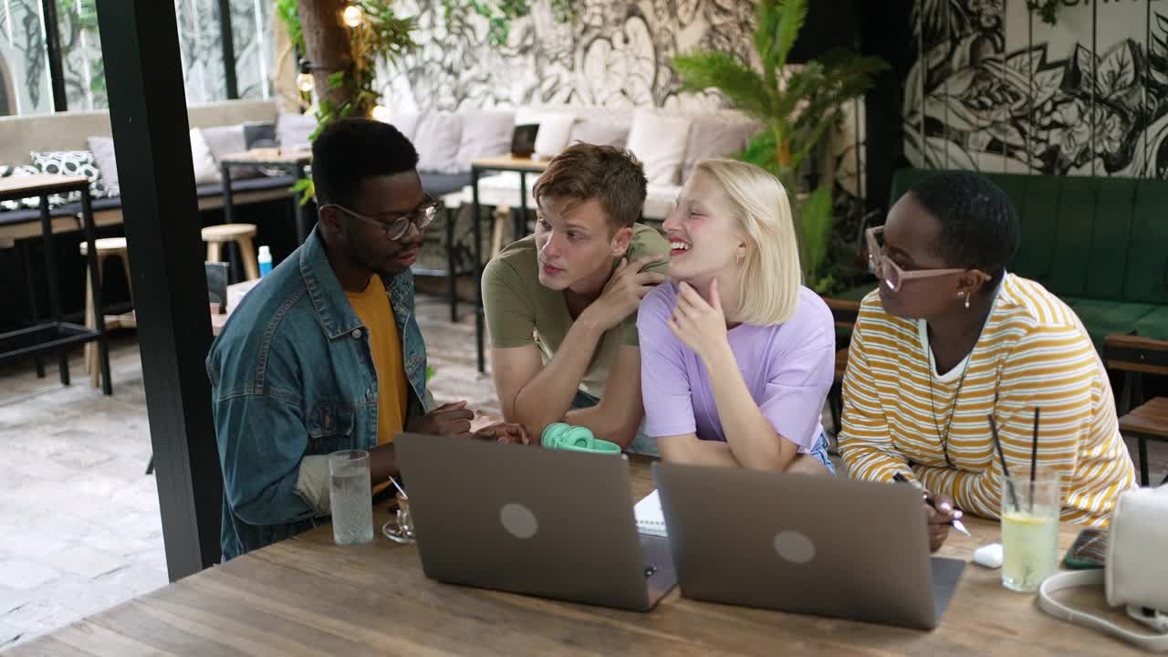 一群多种族的朋友一起看笔记本电脑视频素材