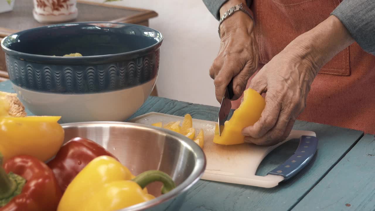 一位年长的女士为午餐做健康沙拉视频素材