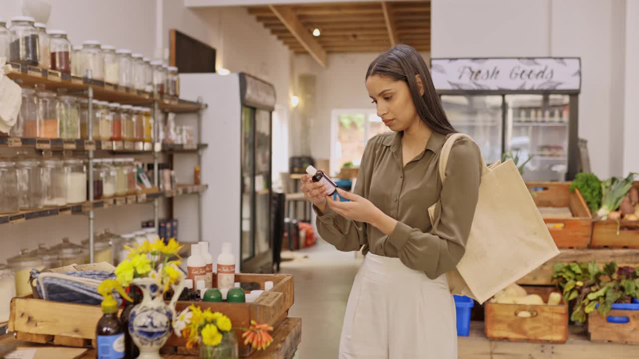 一名年轻顾客在杂货店读瓶子标签的4k视频片段视频素材