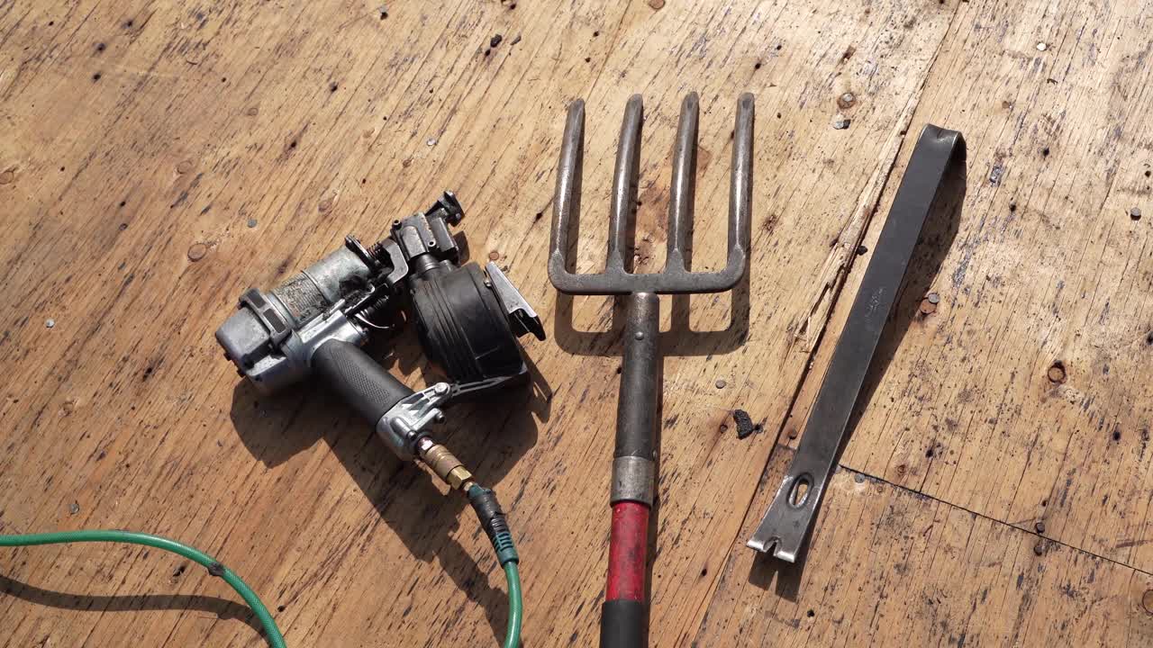 工具带、工具和钉枪躺在沥青或沥青瓦上视频素材