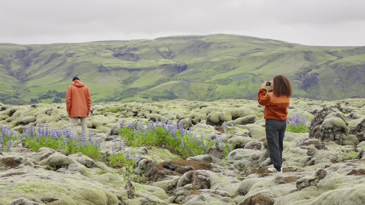 女人在苔藓景观中拍摄男人视频素材