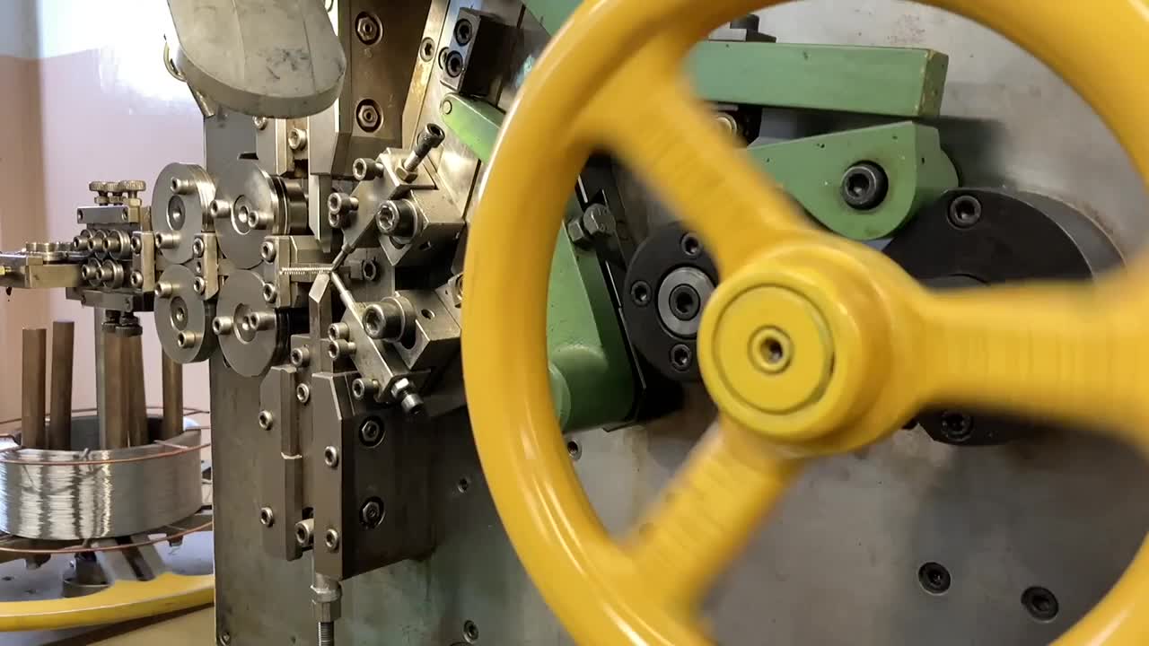 机器上的弹簧绕线。制造弹簧的生产。慢动作视频。视频素材