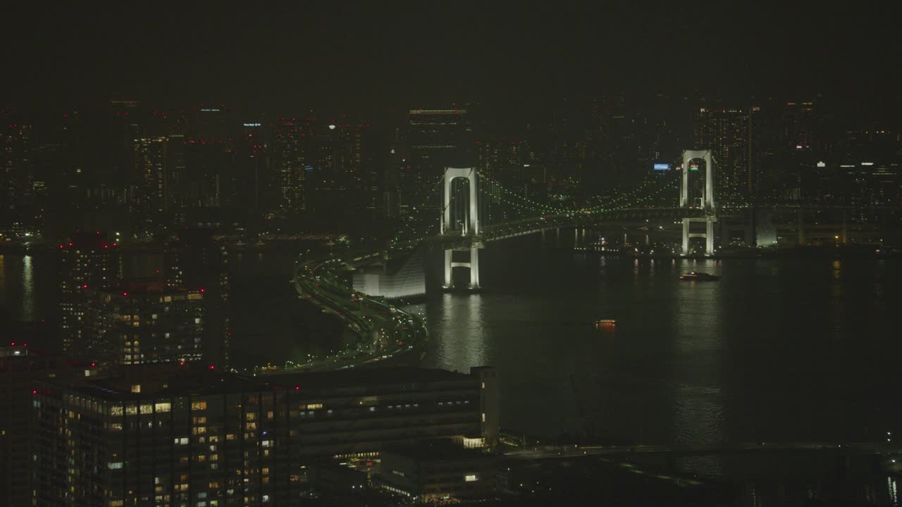 云彩桥横跨东京湾与城市天际线可见在bg。高楼大厦、摩天大楼、办公楼和公寓楼随处可见。视频下载
