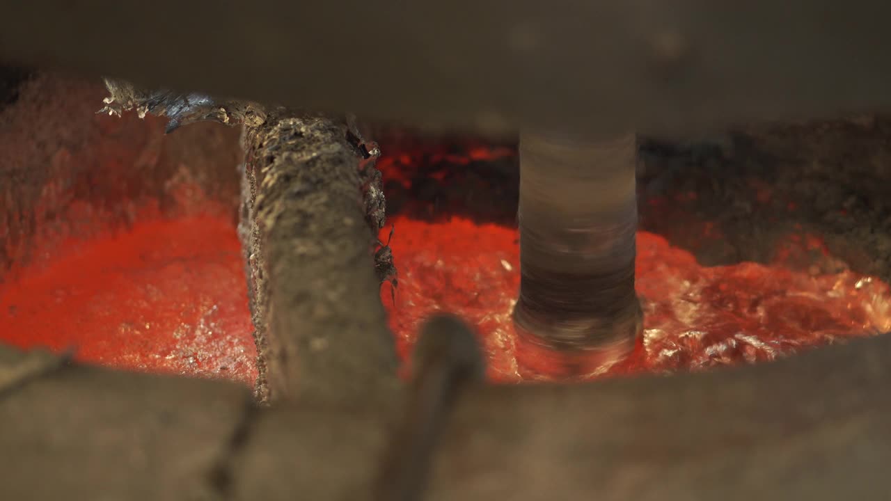 铸造厂在熔炼炉内进行铝熔炼、氮气混合、除渣、清理金属液的工艺视频素材