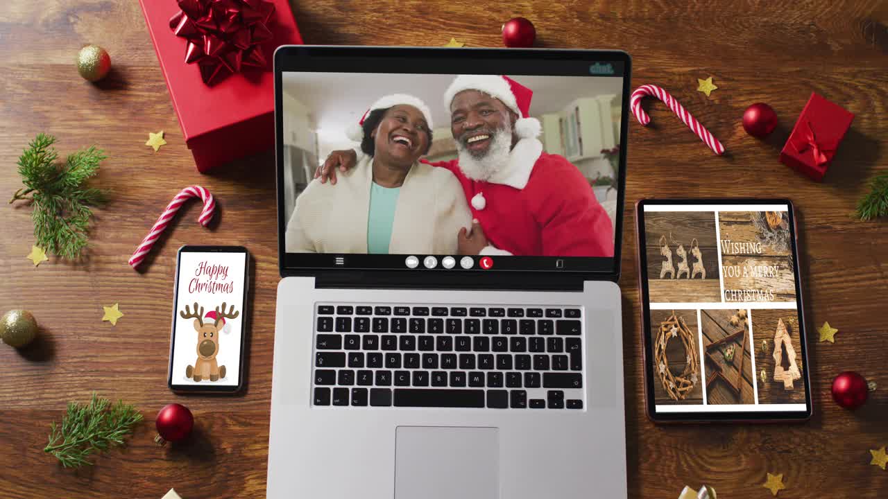 非裔美国老夫妇在笔记本电脑上视频通话，智能手机，平板电脑和装饰视频下载