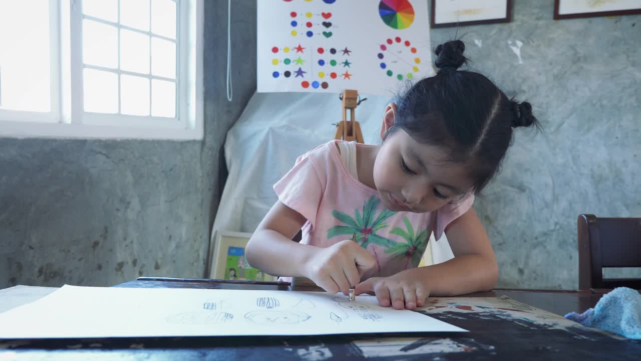 亚洲女孩在家里或小学用纸上用铅笔画画视频下载