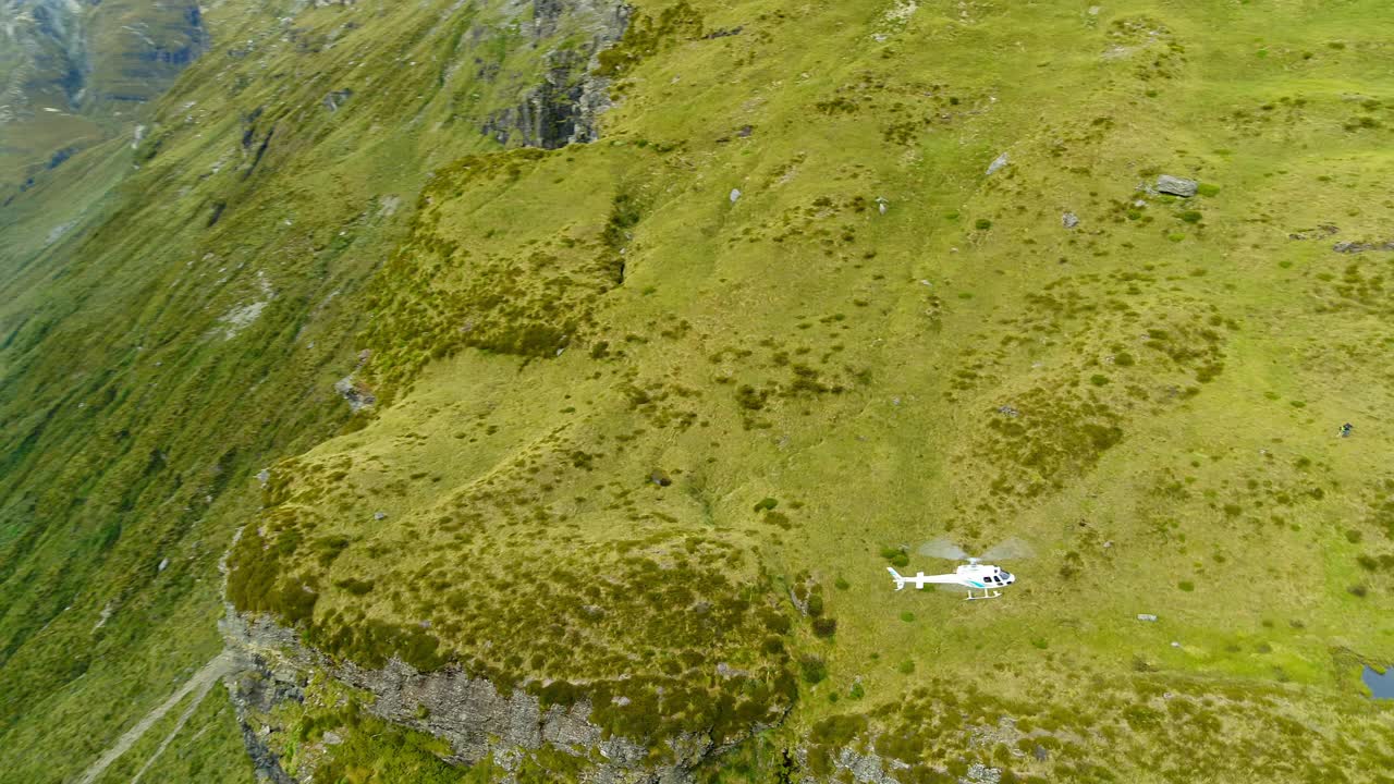 航拍:拍摄直升机飞过绿山的风景-奥克兰，新西兰视频素材