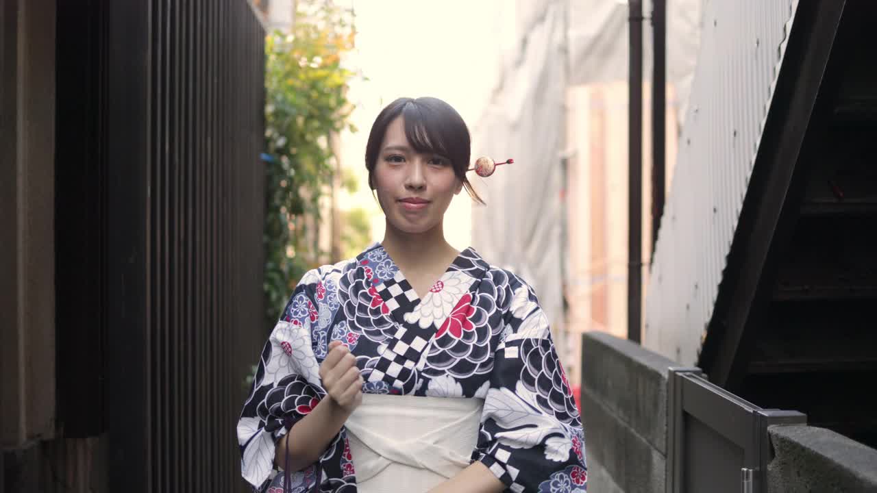 一位日本妇女走在一条狭窄的小径上视频素材
