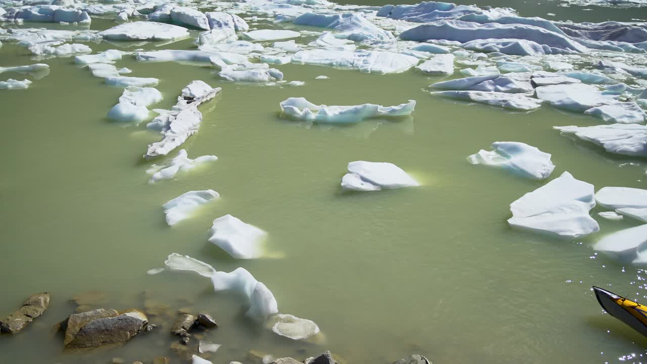 不列颠哥伦比亚省女冒险家在冰山湖上划独木舟视频素材