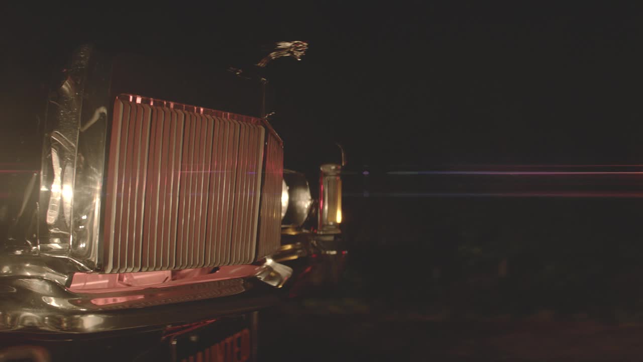 1969年林肯大陆马克iii汽车驾驶引擎盖的闭合角度移动角度。其他汽车和前灯部分可见。树木部分可见。视频素材
