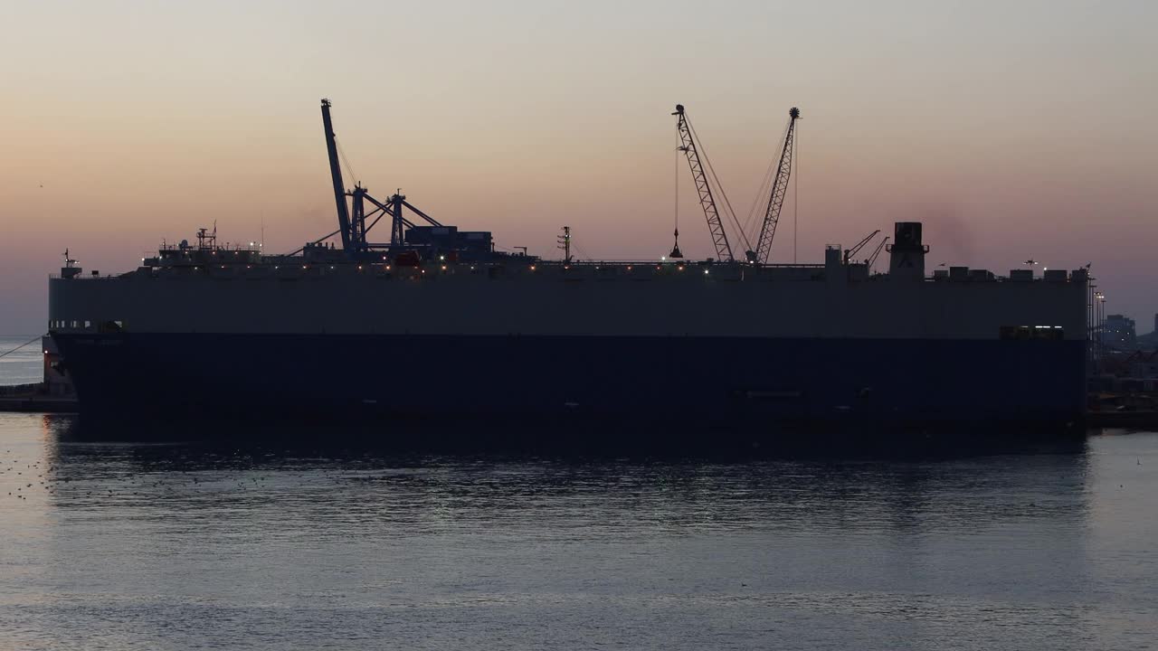 日落时港口里的渡船和货船视频素材